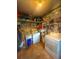 Utility room with washing machine, dryer, storage shelves, and cleaning supplies at 802 Haselton St, Eustis, FL 32726