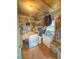 Functional utility room with washer, storage shelves, and a small deep freezer at 802 Haselton St, Eustis, FL 32726