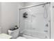 Bright bathroom boasts a white shower with glass doors and white tiled walls at 8256 Maritime Flag St # 103, Windermere, FL 34786