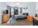 Comfortable bedroom with wood-style flooring, natural light, and tasteful decor at 8256 Maritime Flag St # 103, Windermere, FL 34786
