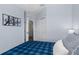 A blue bedroom features an open closet, multiple doors and modern art on the wall at 8256 Maritime Flag St # 103, Windermere, FL 34786