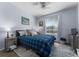 Cozy bedroom with blue bedding, area rug, and side table with black lamp at 8256 Maritime Flag St # 103, Windermere, FL 34786