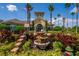 Attractive clubhouse exterior with well-manicured landscaping, a fountain, and palm trees at 8256 Maritime Flag St # 103, Windermere, FL 34786