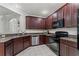 Well-equipped kitchen with stainless steel appliances, dark cabinets, and granite countertops at 8256 Maritime Flag St # 103, Windermere, FL 34786