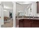 Modern kitchen featuring dark wood cabinets, stainless steel appliances, and granite countertops at 8256 Maritime Flag St # 103, Windermere, FL 34786