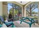 A neutral-colored patio features a blue picnic table and multiple chairs at 8256 Maritime Flag St # 103, Windermere, FL 34786