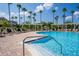 Sparkling blue pool with multiple lounge chairs and shaded pergola areas, perfect for a relaxing day at 8256 Maritime Flag St # 103, Windermere, FL 34786