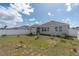 View of the backyard featuring a well-maintained lawn and privacy fence at 853 Laurel View Way, Groveland, FL 34736