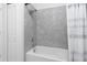Bathroom featuring a tiled tub and shower combination with a shower curtain for privacy at 853 Laurel View Way, Groveland, FL 34736