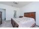 Bright bedroom features carpeted floors and wood furniture, plus an ensuite bathroom for added convenience at 853 Laurel View Way, Groveland, FL 34736