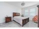 Comfortable bedroom with carpeted floors, two windows, and wood furniture offering a relaxing retreat at 853 Laurel View Way, Groveland, FL 34736