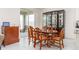 Elegant dining room area with a wooden table and a glass display cabinet, with plenty of natural light at 853 Laurel View Way, Groveland, FL 34736