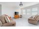 Bright living room with a TV on a wood cabinet and a comfortable sofa with throw pillows at 853 Laurel View Way, Groveland, FL 34736