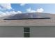 Roof with modern solar panels, providing energy efficiency to this home at 853 Laurel View Way, Groveland, FL 34736