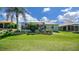 Grassy backyard includes screened patio, perfect for outdoor relaxation and entertainment at 9019 Se 177Th Grassmere St, The Villages, FL 32162
