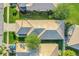 Aerial view of a home with a tile roof, lush landscaping, and a well-maintained yard at 9081 Saint Andrews Way, Mount Dora, FL 32757