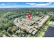 Expansive aerial view of neighborhood with well-maintained homes and lush greenery at 9081 Saint Andrews Way, Mount Dora, FL 32757