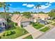 Aerial view showcases a well-kept neighborhood with manicured lawns and similar single-story homes at 9081 Saint Andrews Way, Mount Dora, FL 32757