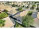 Aerial view of the home with well-maintained landscaping, a screened-in porch, and tile roof at 9081 Saint Andrews Way, Mount Dora, FL 32757