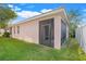 Exterior view of the screened-in porch with a lush green yard at 9081 Saint Andrews Way, Mount Dora, FL 32757