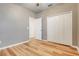 Bright bedroom features wood-look flooring and a spacious closet for ample storage at 9081 Saint Andrews Way, Mount Dora, FL 32757