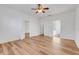 Bedroom with wood flooring, and multiple entry door, with neutral paint at 9081 Saint Andrews Way, Mount Dora, FL 32757