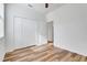 Bright bedroom features wood-look flooring and a spacious closet for ample storage at 9081 Saint Andrews Way, Mount Dora, FL 32757