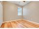 Bedroom features hard wood flooring and a window at 9081 Saint Andrews Way, Mount Dora, FL 32757