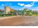 Elegant clubhouse with well-manicured grounds and inviting entrance at 9081 Saint Andrews Way, Mount Dora, FL 32757