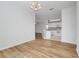 Dining area with wood flooring and kitchen view with modern appliances at 9081 Saint Andrews Way, Mount Dora, FL 32757