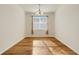 Bright dining room features wood floors and a large window at 9081 Saint Andrews Way, Mount Dora, FL 32757