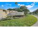 Elegant community entrance sign surrounded by vibrant landscaping and manicured lawn at 9081 Saint Andrews Way, Mount Dora, FL 32757