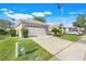 Beautiful one-story home with a two-car garage, attractive landscaping, and a well-maintained driveway at 9081 Saint Andrews Way, Mount Dora, FL 32757
