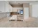 Well-appointed kitchen featuring stainless steel appliances, ample counter space, and white cabinetry at 9081 Saint Andrews Way, Mount Dora, FL 32757