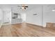 Open-concept living space with wood floors, flowing into the kitchen and entryway for easy living at 9081 Saint Andrews Way, Mount Dora, FL 32757