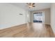 Spacious living room with wood flooring, neutral walls, and sliding doors leading to outdoor space at 9081 Saint Andrews Way, Mount Dora, FL 32757