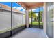 Relaxing screened-in porch overlooking the backyard with lush landscaping and a serene view at 9081 Saint Andrews Way, Mount Dora, FL 32757