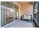 Relaxing covered porch with comfortable seating and sliding glass doors to the interior at 9081 Saint Andrews Way, Mount Dora, FL 32757