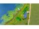 Aerial view showcases a home with lake access, a private dock, and surrounding greenery at 9510 Suggs Rd, Clermont, FL 34711