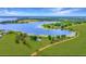 Aerial view of a lakeside home with a sprawling lawn and beautiful water access at 9510 Suggs Rd, Clermont, FL 34711