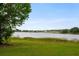 Backyard featuring a lake view and tree coverage offering tranquil scene at 9510 Suggs Rd, Clermont, FL 34711