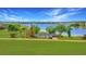 Waterfront property featuring a lake view and a charming single story home surrounded by mature trees at 9510 Suggs Rd, Clermont, FL 34711