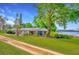 Charming single-story home with a large yard, mature trees, and stunning lake views at 9510 Suggs Rd, Clermont, FL 34711