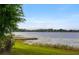 Beautiful lake view featuring a wooden dock and peaceful scenery at 9510 Suggs Rd, Clermont, FL 34711