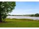 Beautiful lake view highlighting a serene waterfront scene with trees and greenery adding to the peaceful setting at 9510 Suggs Rd, Clermont, FL 34711