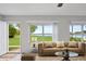 Bright living room with neutral décor, large windows offering serene lake views at 9510 Suggs Rd, Clermont, FL 34711