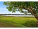 Expansive green yard leading to the tranquil lake, offering serene views at 9510 Suggs Rd, Clermont, FL 34711
