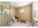 Bright bathroom featuring a walk-in shower, and built-in storage cabinets at 9645 Se 173Rd Pl, Summerfield, FL 34491