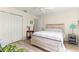 Well-lit bedroom featuring wood-look flooring, a ceiling fan and closet at 9645 Se 173Rd Pl, Summerfield, FL 34491