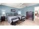 Inviting bedroom with twin beds, bright blue walls, and a large dresser for ample storage at 9645 Se 173Rd Pl, Summerfield, FL 34491